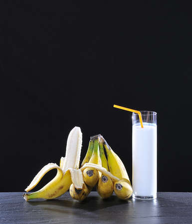 Banana milkshake isolated on a black background.の写真素材