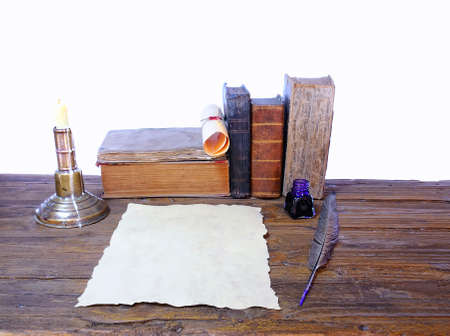 Work desk with parchment and old books の写真素材