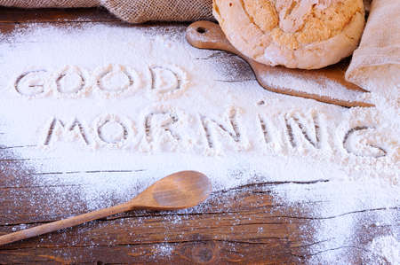 Flour on the table of the bakery with the phrase Good Morning 