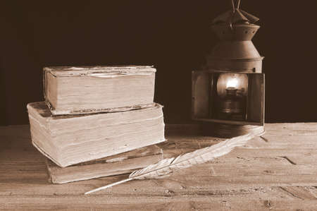 Old books on the table and lantern の写真素材