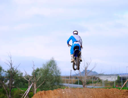 Motocross racer giving a jump with his bike 