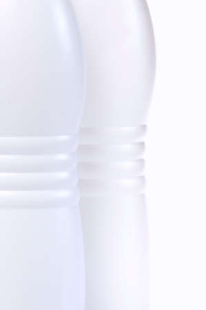 Detail of bottles of milk isolated on white background.の写真素材