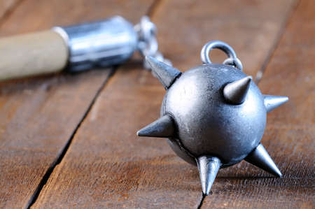 A medieval mace on a wooden table.の写真素材