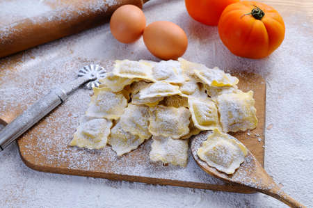 Preparing fresh ravioli at the kitchen table.の写真素材