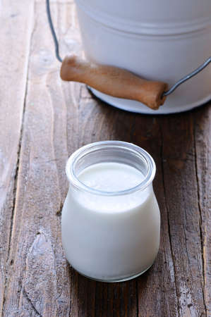Homemade yogurt on wooden table in the kitchenの写真素材