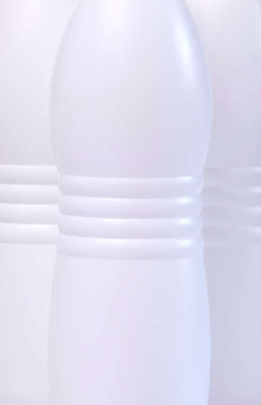 Detail of bottles of milk isolated on white background.の写真素材