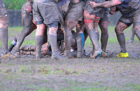 Detail muddy boots in a rugby match.の写真素材