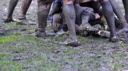 Detail muddy boots in a rugby match.の写真素材