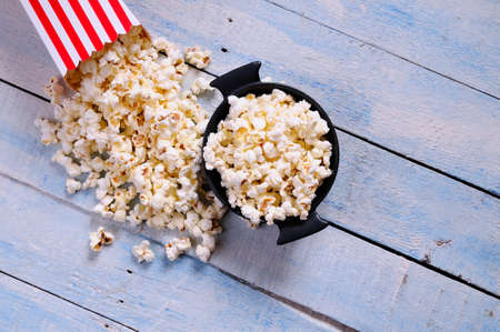 Freshly made popcorn on a wooden tableの写真素材