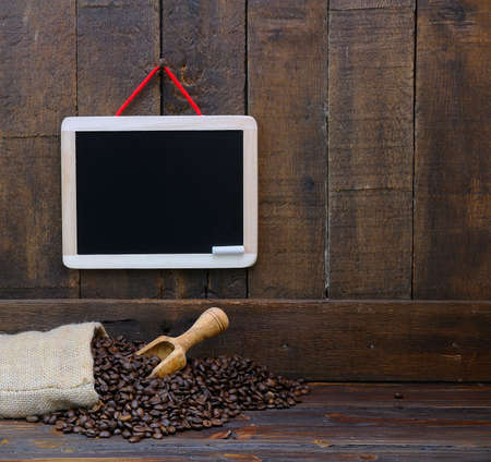 Coffee beans with blackboard on a wooden table.の写真素材