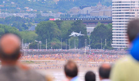 GIJON, SPAIN - JULY 28: GijÃ³n air festival concluded on July 28, 2013 in Gijon, Asturias. A Harrier of the Spanish air forces maneuver on the beach of St. Lorenzo in Gijon.のeditorial素材