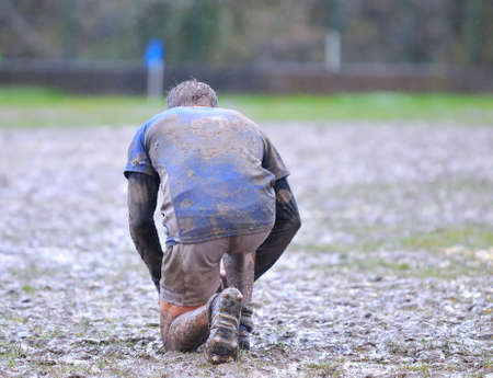 Detail muddy boots in a rugby match.の写真素材
