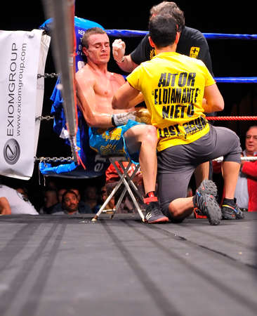 OVIEDO, SPAIN - MAY 16: Aitor Nieto of Spain beat Estonian Pavel Mamontov by decision to win the European IBF and USBA welterweight championship in May 16, 2015 in Oviedo, Spain. Aitor Nieto sitting in the corner of the ring treated by his assistant.のeditorial素材