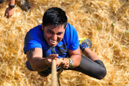 LEON, SPAIN - JUNE 6: Farinato Race, extreme obstacle race in June 6, 2015 in Leon, Spain. People jumping, crawling,passing under a barbed wires or climbing obstacles during extreme obstacle race.のeditorial素材