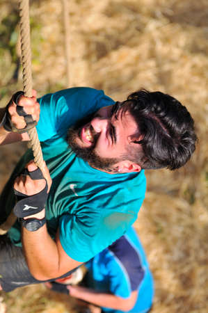 LEON, SPAIN - JUNE 6: Farinato Race, extreme obstacle race in June 6, 2015 in Leon, Spain. People jumping, crawling,passing under a barbed wires or climbing obstacles during extreme obstacle race.のeditorial素材