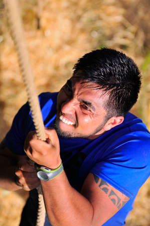 LEON, SPAIN - JUNE 6: Farinato Race, extreme obstacle race in June 6, 2015 in Leon, Spain. People jumping, crawling,passing under a barbed wires or climbing obstacles during extreme obstacle race.のeditorial素材