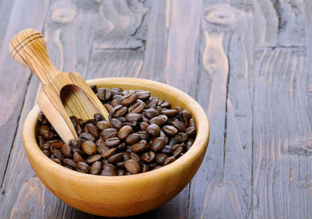 Coffee beans of the highest quality on the wooden table.の写真素材