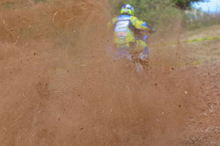 Motocross rider on a muddy trackの写真素材