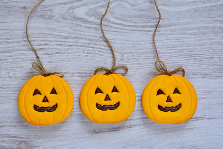 Halloween cookies with pumpkin shape on the kitchen tableの写真素材