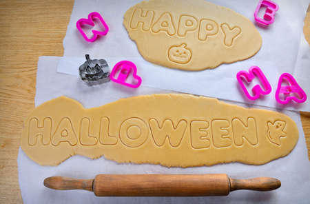 Halloween cookies with pumpkin shape on the kitchen tableの写真素材
