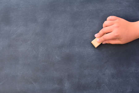 Someone's hand cleaning the chalkboard. Unrecognizableの写真素材