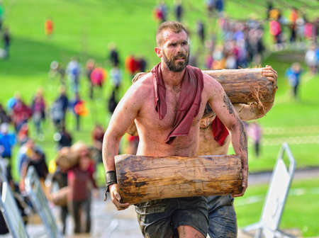 GIJON, SPAIN - JANUARY 31: Farinato Race, extreme obstacle race in January 31, 2016 in Gijon, Spain. People jumping, crawling,passing under a barbed wires or climbing obstacles during extreme obstacle race.のeditorial素材