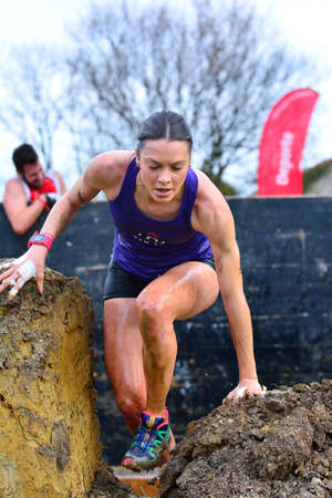 GIJON, SPAIN - JANUARY 31: Farinato Race, extreme obstacle race in January 31, 2016 in Gijon, Spain. People jumping, crawling,passing under a barbed wires or climbing obstacles during extreme obstacle race.のeditorial素材