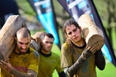 GIJON, SPAIN - JANUARY 31: Farinato Race, extreme obstacle race in January 31, 2016 in Gijon, Spain. People jumping, crawling,passing under a barbed wires or climbing obstacles during extreme obstacle race.のeditorial素材