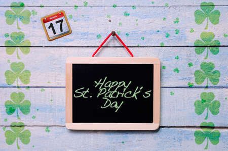 Blackboard hanging on a old wooden wall with St. Patrick?s Day.の写真素材