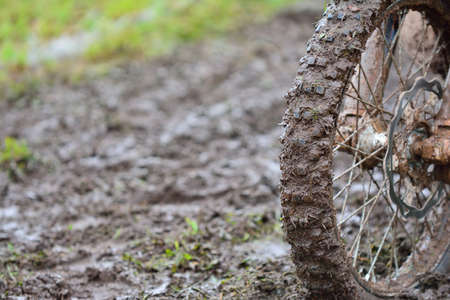 Close-up of dirty wheel of motocross bike in mud. Bokeh.の写真素材