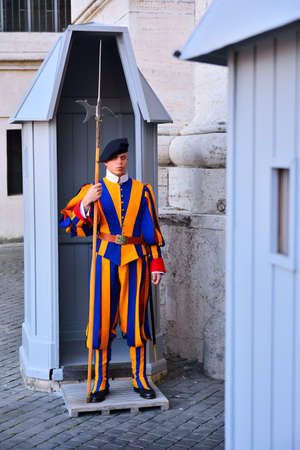 VATICAN CITY, VATICAN - APRIL 12: Papal Swiss guard stand guard at the entrance of Saint Peter's Basilica on April 12, 2017. Swiss Guard in their traditional uniform.のeditorial素材