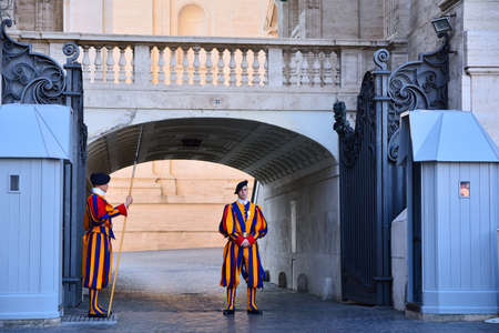 VATICAN CITY, VATICAN - APRIL 12: A pair of Papal Swiss guards stand guard at the entrance of Saint Peter's Basilica on April 12, 2017. Swiss Guards in their traditional uniform.のeditorial素材