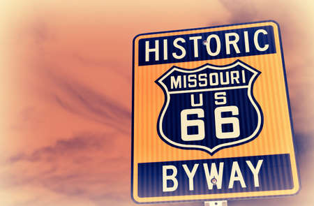 Historic route 66 highway sign in Missouri USA. Red sky backgroundの写真素材