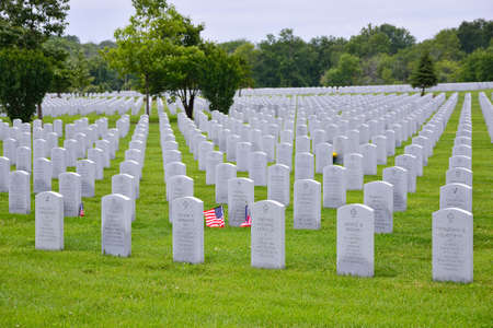 ELWOOD, ILLINOIS / USA - JULY 16: Two small American flags honors the gravesite of World War II veterans and Vietnam veterans at Abraham Lincoln National Cemetery on July 16, 2017 in Elwood, Illinois.のeditorial素材