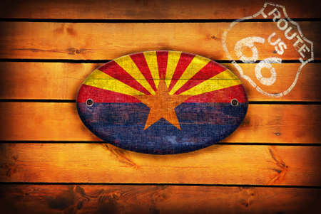 Brown wooden planks with the Arizona flag and shield of Route 66.の写真素材