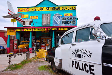 Seligman, AZ, Usa - July 24, 2017: 1953 Chrysler Police Car in front of Historic Seligman Sundries Cafe on Route 66, Arizona.のeditorial素材