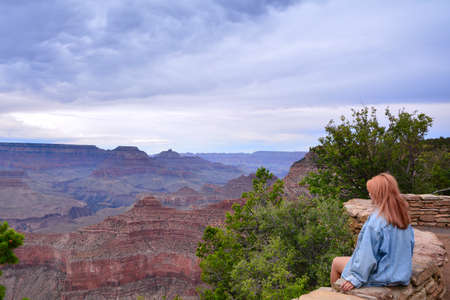Beautiful woman looking out at the Grand Canyon from the South Rim, Usa.の写真素材