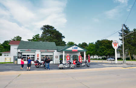 DWIGHT, IL - USA - JULY 16: Old Texaco gas station in Route 66 on July 16, 2017, in Dwight, Illinois. Group of motorcyclists resting with their motorcyclesのeditorial素材