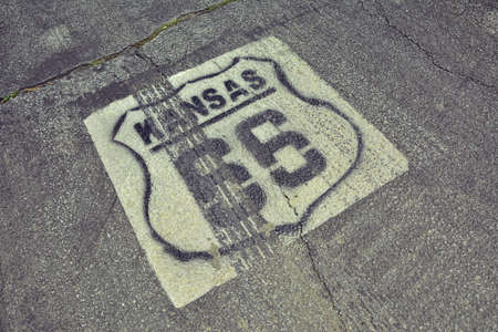 Historic Route 66 marker in Kansas on asphalt.の写真素材