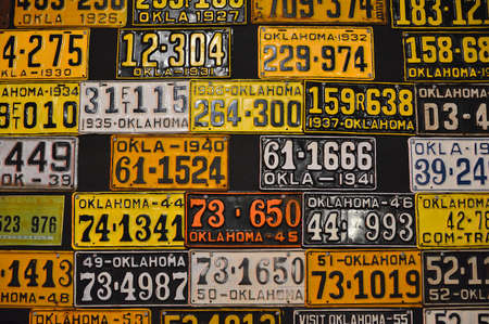 Oklahoma, Usa - July 20, 2017: Various old American license plates on wall. License plates are from...