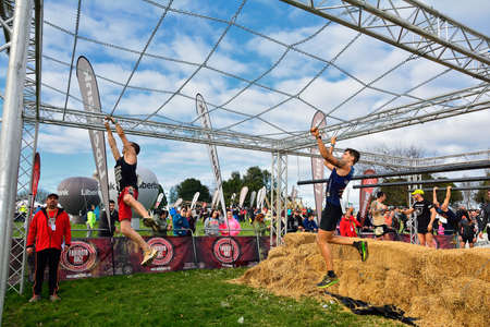 Gijon, Spain - January 21: Farinato Race, extreme obstacle race in January 21, 2018 in Gijon, Spain. People jumping, crawling,passing under a barbed wires or climbing obstacles during extreme obstacle race.のeditorial素材
