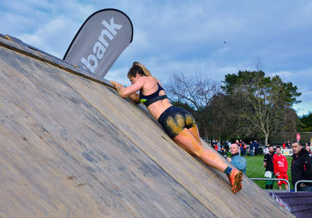 Gijon, Spain - January 21: Farinato Race, extreme obstacle race in January 21, 2018 in Gijon, Spain. People jumping, crawling,passing under a barbed wires or climbing obstacles during extreme obstacle race.のeditorial素材