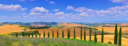 Tuscany, Italy - July 5, 2018: Cypress trees and meadow with typical tuscan house, Val d'Orcia, Italy - Tuscanyのeditorial素材