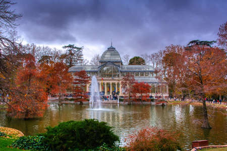Madrid, Spain, November 30, 2019: Crystal Palace in Retiro Park in Madrid. Autumn colorful view with people, trees, plants and environment.のeditorial素材
