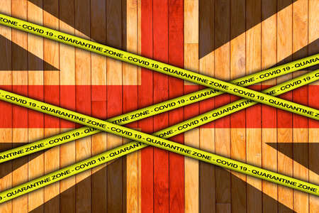 COVID-19 warning yellow ribbon written with: Quarantine zone Cover 19 on United Kingdom flag...