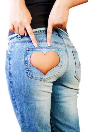 Girl in jeans with heart-shaped hole on the buttock, indicates the two fingersの写真素材
