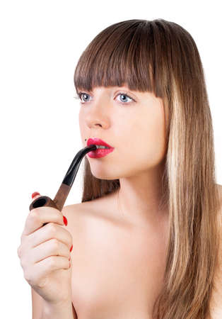 The beautiful young woman with a pipe near lipsの写真素材