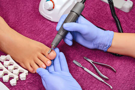 Process pedicure close-up, polishing feet, unrecognizable peopleの写真素材