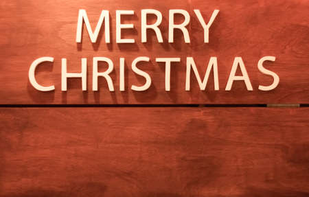 White text merry Christmas on wooden backgroundの写真素材