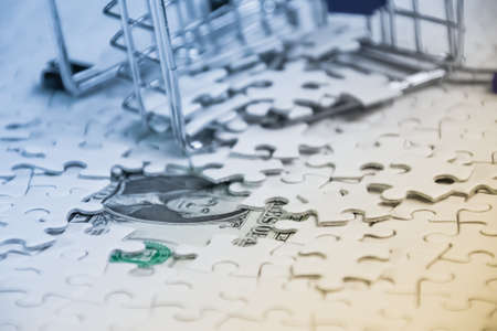 crashed shopping cart with a lot of  white jigsaw puzzle, Failed business concept, Shopping online conceptの写真素材